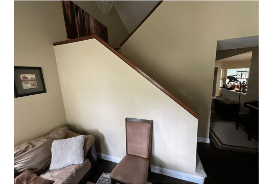 Enclosed staircase with solid half wall before Guardian Shield Windows & Doors remodel