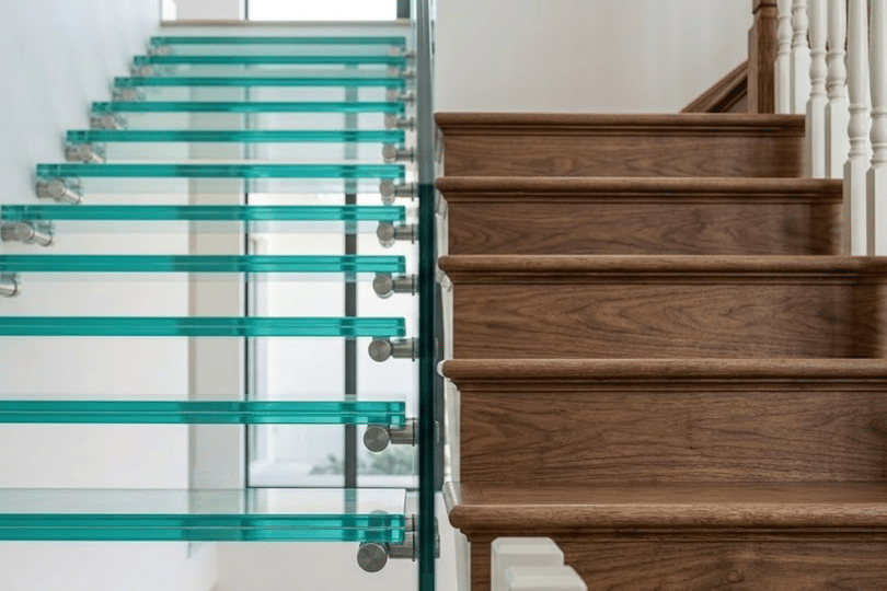 Close-up comparison showing floating glass staircase steps on the left and traditional wooden stair treads on the right